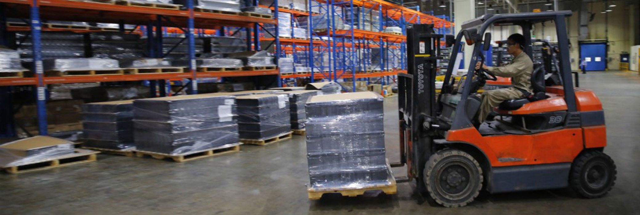 Factory Worker Moving Pallet with Forklift