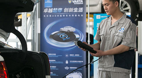 Technician Analyzing Car Vitals through Car Trunk